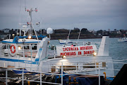 A fisherman boat with a banner reading 