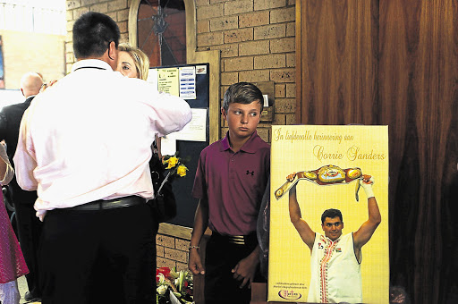 Corrie Sanders' 12-year-old son, Dean, at the funeral service for the legendary boxer at Wonderpark NG Kerk in Pretoria yesterday. Dean was one of the pallbearers Picture: ALON SKUY