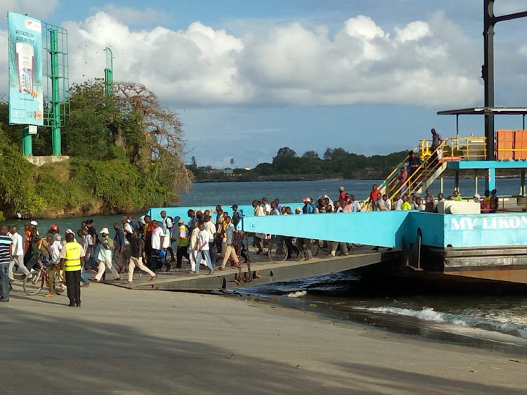 Commuters disembark from MV Likoni on Tuesday evening.