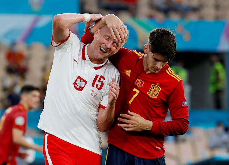Spain's Alvaro Morata in action with Poland's Kamil Glik