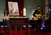 A candle and a portrait of British MP David Amess, who was stabbed to death during a meeting with constituents, are seen at the church of St Michael's and all Angels, in Leigh-on-Sea, Britain, October 17, 2021.