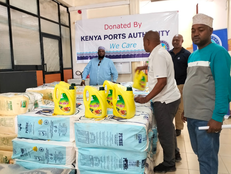 Kenya Ports Authority-KPA Principal Corporate Communications Officer, Haji Masemo (in white T-Shirt) goes through the consignment of food before it was handed to Lamu muslim clerics.