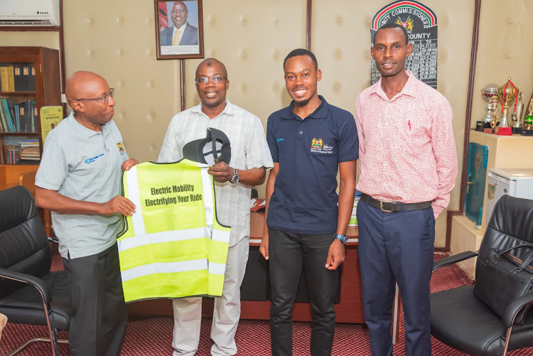 National e-Mobility Policy, 2024, draft taskforce member Michael Muchiri (left) and Garissa County Commissioner Mohamed Mwabudzo (second left) during a courtesy call before holding a public participation forum, April 22, 2024.