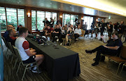 Eddie Jones, (C) the England head coach, faces the media with the defence coach John Mitchell (L) and Owen Farrell during the England media session on October 22, 2019 in Tokyo, Japan. 