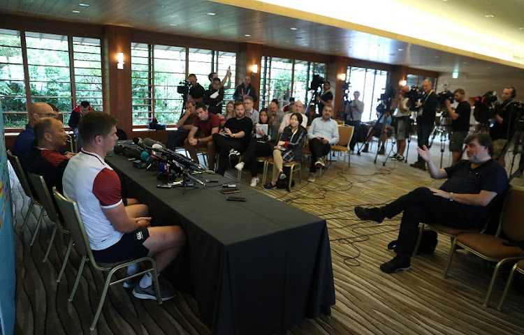 Eddie Jones, (C) the England head coach, faces the media with the defence coach John Mitchell (L) and Owen Farrell during the England media session on October 22, 2019 in Tokyo, Japan.