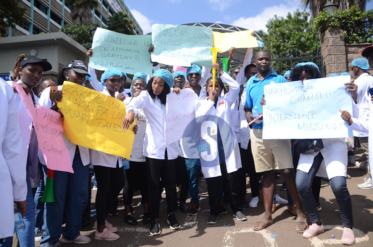 Graduate medical students with placards, whistles and vuvuzelas outside Afya House as they protest over delays by the Ministry of Health in posting them for internship on February 12, 2024