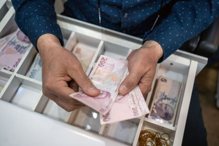 A vendor counts Turkish lira banknotes inside a shop in Ankara, Turkey, May 29 2023. Picture: MOE ZOYARI/BLOOMBERG