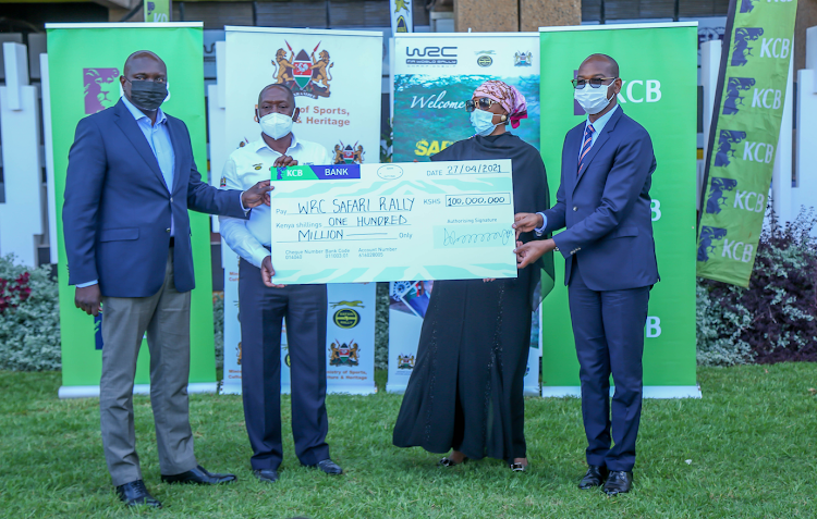 KCB Group CEO and MD Joshua Oigara (R) hands over a dummy cheque of Sh100m to Cabinet Secretary for Sports Amina Mohamed, WRC Safari Rally Kenya CEO Phineas Kimathi and Principal Secretary for Sports Joe Okudo at Moi Stadium, Kasarani on April 27.