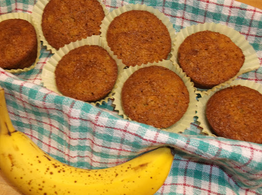 Banana muffins in towel lined basket.