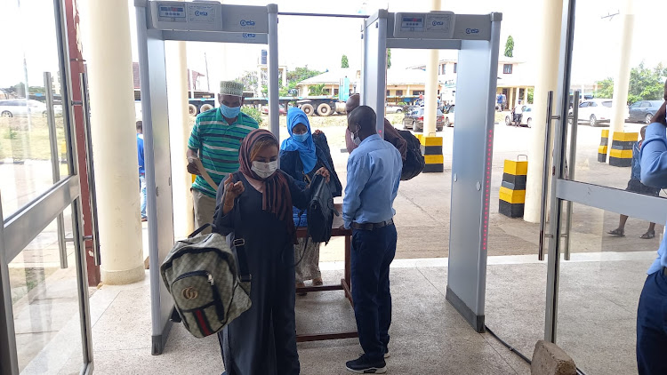 Traders pass through a screening machine at the Lunga-Lunga One Stop Border Post in Kwale on Wednesday, June 21, 2022.
