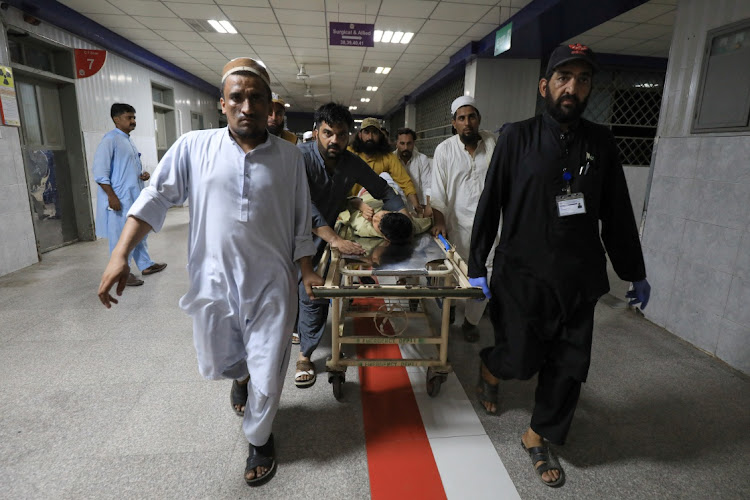 People transport an injured man at the Lady Reading Hospital in Peshawar, Pakistan, July 30 2023. Picture: FAYAZ AZIZ/REUTERS