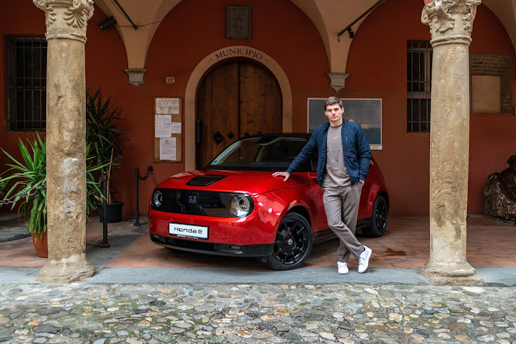 Max Verstappen poses with the Honda e Limited that's available in Europe only.