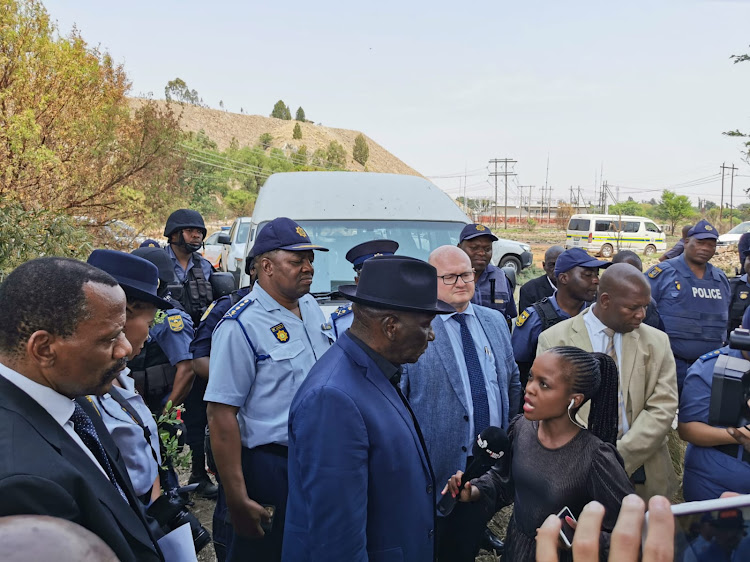 Police minister Bheki Cele visited the scene of a police raid at a disused mine shaft in Stilfontein, where 20 illegal mining suspects were arrested and 24 rifles seized.