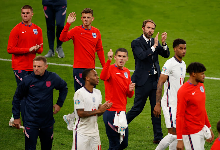 England coach Gareth Southgate leads dejected players in applauding the fans after the match.