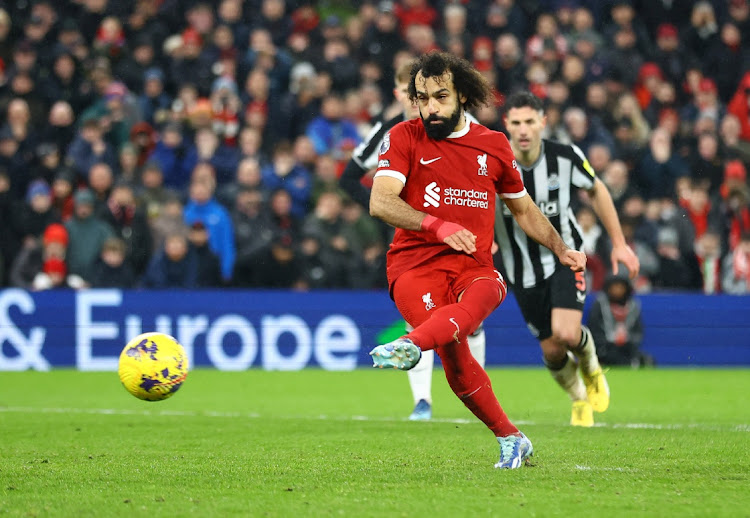 Mohamed Salah scores Liverpool's fourth goal from the penalty spot in their Premier League win against Newcastle United at Anfield on Monday.