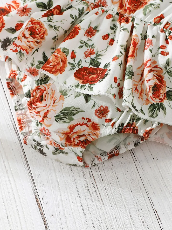 Mouwloze kleine bloemen driehoek romper voor babymeisjes met hoofdband. Schattig en comfortabel voor warme dagen, ideaal voor spelen.