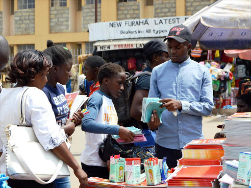 Parents and students buy books from a vendor in Kakamega's open market, January 2018. /FILE