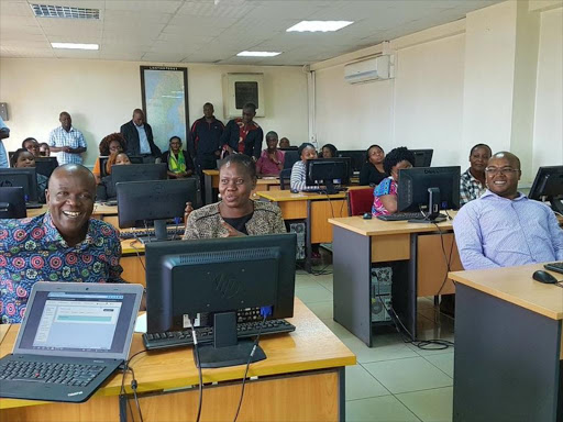 Lands CAS Gideon Mung'aro, CS Farida Karoney and PS Nicholas Muraguri at a digitisation training session for ministry officials in 2018.