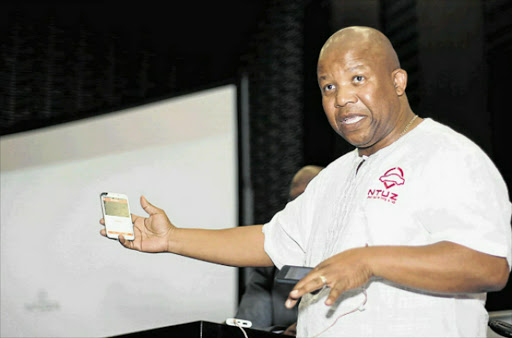 GROUNDBREAKING: Eugene 'Ntuza' Ntuthuzelo Mfaka displays the new taxi app Picture: SISIPHO ZAMXAKA