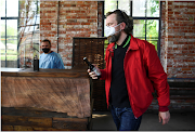 A man leaves the test center with a free beer after getting a coronavirus disease test on the premises of the brewing company BrewDog beside their DogTap restaurant, in Berlin, Germany May 11, 2021. 
