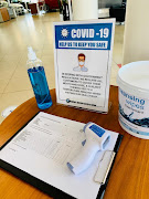 The new normal: customers are required to sanitise their hands and have a temperature reading before entering this dealership. Picture: SUPPLIED