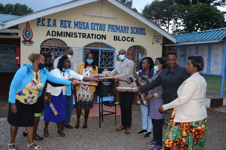 Kiambu county education officials hand water containers and soap to PCEA Rev Musa Gitau Primary School.