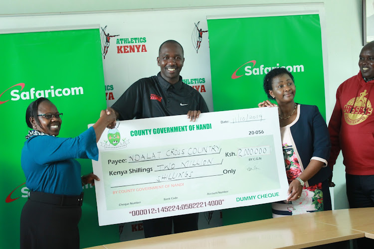 From left: Nandi County deputy governor Euliter Cheruiyot shakes hands with AK Central Rift chairman Abraham Mutai with AK's acting CEO Susan Kamau during the Isaiah Kiplagat Ndalat Gaa Cross Country launch on October 11.