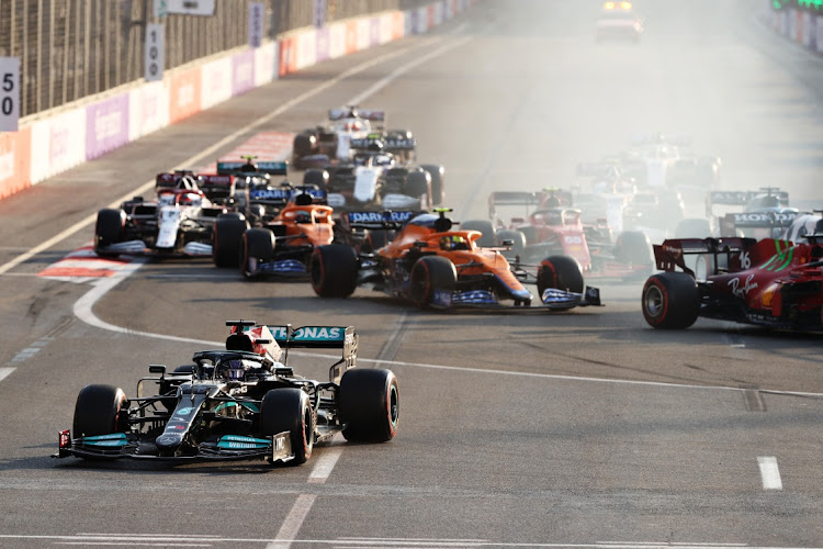 Lewis Hamilton of Great Britain driving the Mercedes AMG Petronas F1 Team Mercedes W12 runs wide after locking up at the restart following a red flag period during the F1 Grand Prix of Azerbaijan at Baku City Circuit on June 6, 2021 in Baku, Azerbaijan