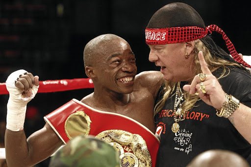 IBF flyweight champion Moruti Mthalane celebrates with trainer Nick Durandt after stopping challenger Zolani Tete in September 2010 at Carnival City in Brakpan. / Antonio Muchave.