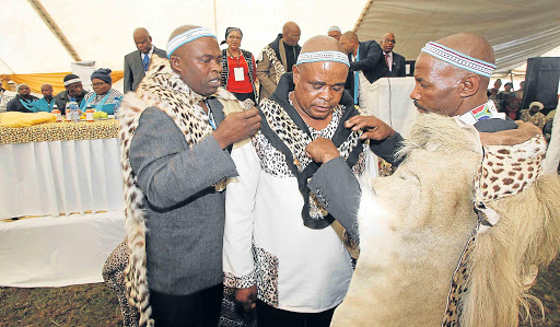 ROYAL BLOOD: AmaXhosa King Mpendulo Zwelonke Sigcawu, right, officiates at the royal enrobing of Chief Mthetho Ngubesizwe Sigcawu, centre, who is the head of amaGcaleka aseGwadana at an event held at his Ngxakaxha Great Place near Dutywa on Friday. Left is chief Sibongile Dumalisile, also of the Tshawe dynasty Picture: LULAMILE FENI