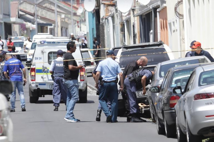 Police examine the car in which Rashied Staggie was killed on December 13 2019.