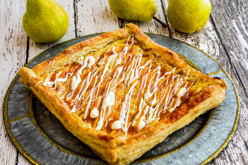 Pam's Rustic Caramel Pear Tart with caramel sauce and white chocolate on top.