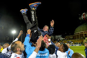 Bidvest Wits head coach Gavin Hunt hoisted in the air by the team after the Clever Boys won the 2016/17 PSL champions at the Absa Premiership following a match against Polokwane City at Bidvest Stadium on May 17, 2017 in Johannesburg, South Africa.