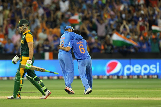 Mohit Sharma of India celebrates with team-mate Suresh Raina of India after taking the wicket of Faf du Plessis of South Africa during the 2015 ICC Cricket World Cup match between South Africa and India at Melbourne Cricket Ground. Picture Credit: Getty Images