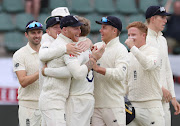 England's Joe Root celebrates taking the wicket of South Africa's Pieter Malan with teammates.