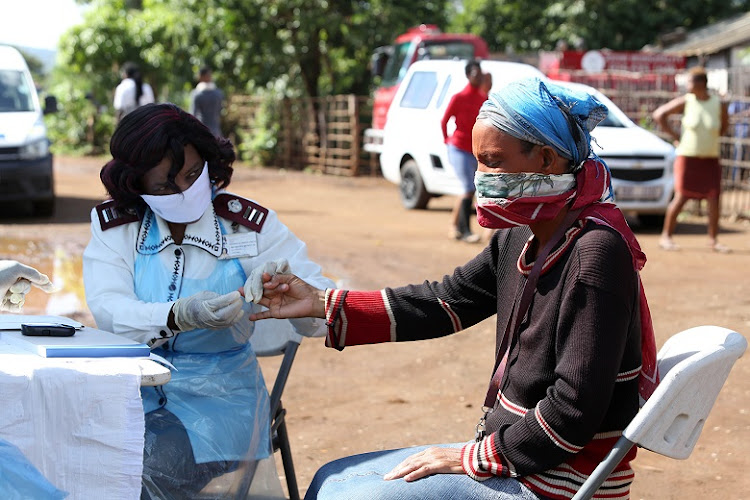 A nurse tests a resident during a sanitation programme of informal settlements in Mkhuze, Northern Zululand.