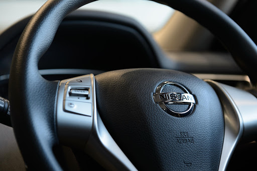 The Nissan Motor Co. badge is displayed on the steering wheel of a vehicle at the company's showroom in Yokohama, Kanagawa Prefecture, Japan, on Wednesday, May 13, 2015. Nissan plans to build more than 1 million vehicles in Japan next year for the first time since 2013, as the weaker yen boosts earnings from exports. Photographer: Akio Kon/Bloomberg