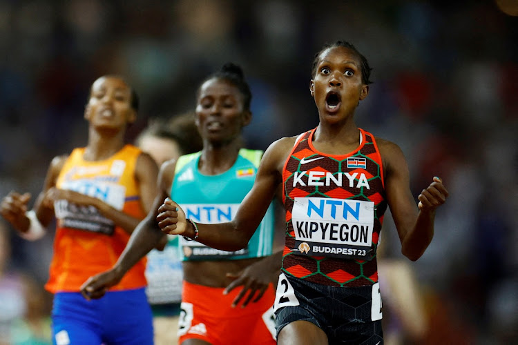 Kenya's Faith Kipyegon reacts as she crosses the line to win the women's 1500m final ahead of second-placed Ethiopia's Diribe Welteji and third-placed Netherlands' Sifan Hassan at the World Athletics Championship at the National Athletics Centre in Budapest, Hungary on Tuesday night.