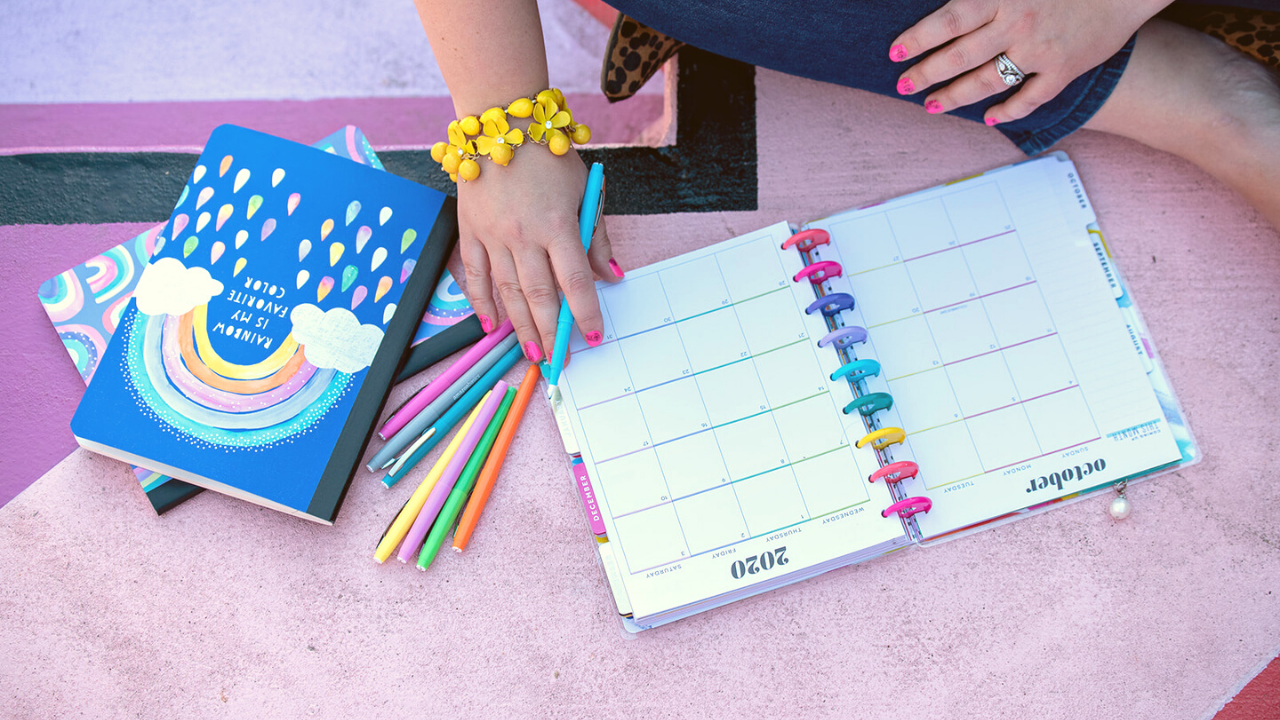 Woman writing in planner to organize your business