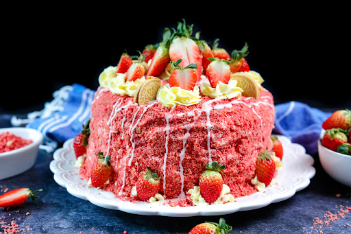 Decorated Strawberry Crunch Cake ready to be sliced.