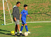 Junaid Hartley  at his one on one coaching with a child called Keenan Schofield Education Through Soccer Academy.  Picture credi:  Veli Nhlapo/ Sowetan