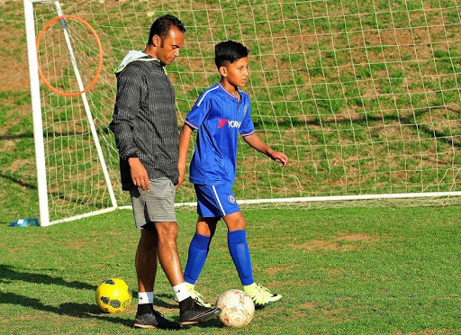 Junaid Hartley at his one on one coaching with a child called Keenan Schofield Education Through Soccer Academy. Picture credi: Veli Nhlapo/ Sowetan