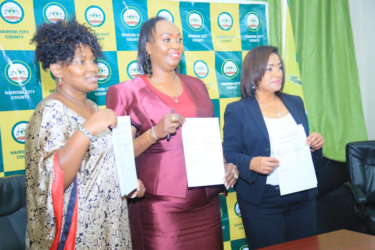 Chief Administrative Secretary for Gender Rachael Shebesh , Nairobi Governor Ann Kananu and Nairobi Woman Representative Esther Pasarris during the signing of MoU to construct Sh88 million SGBV safe house on March 8, 2022