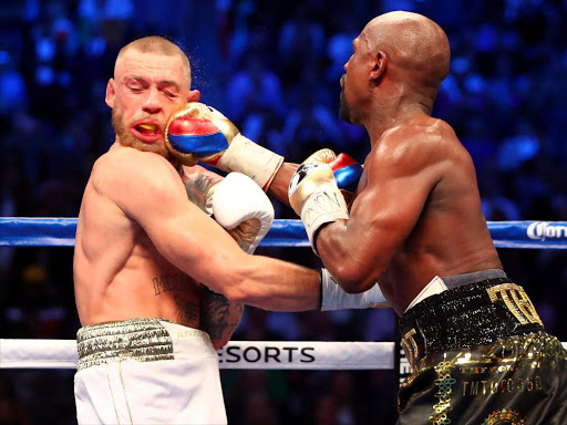 Aug 26, 2017; Las Vegas, NV, USA; Floyd Mayweather Jr. lands a hit against Conor McGregor during the tenth round at T-Mobile Arena.