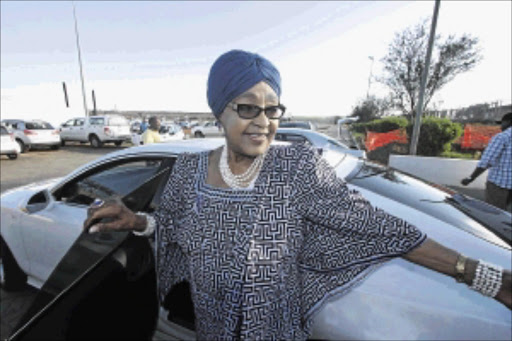 DEFIANT: Winnie Madikizela-Mandela at Mthatha Airport on Sunday, after attending a cleansing ritual in Qunu to mark a year since Nelson Mandela's death photo: LULAMILE FENI