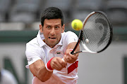 Novak Djokovic of Serbia plays a backhand on his way to a win against Rogerio Dutra Silva of Brazil at Roland Garros yesterday.  