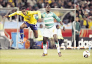 talented: Brazilian striker Juan clears the ball from Ivory Coast defender Emmanuel Eboue during their World Cup match at Soccer City in Johannesburg on Sunday evening. Pic. ANTONIO MUCHAVE.  20/06/2010. © Sowetan.