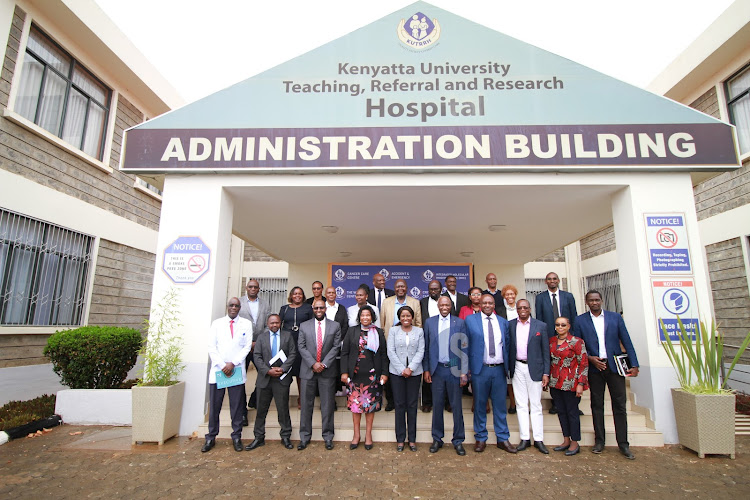 KUTRRH CEO Ahmed Dagane, KUTRRH Chairperson Olive Mugenda, Higher Education Principal Secretary Beatrice Inyangala and Kenyatta University Vice Chancellor Paul Wainaina pose for a photo with other stakeholders after a consultative meeting at the Kenyatta University Teaching, Reasearch and Referral Hospital in Nairobi on October 16, 2023.