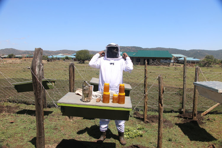 Dupoto Cooperative Society chairman Benson Kataka displays harvested honey