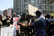 An MK vet exchanges some heated words with a policeman during a march in Durban on Monday